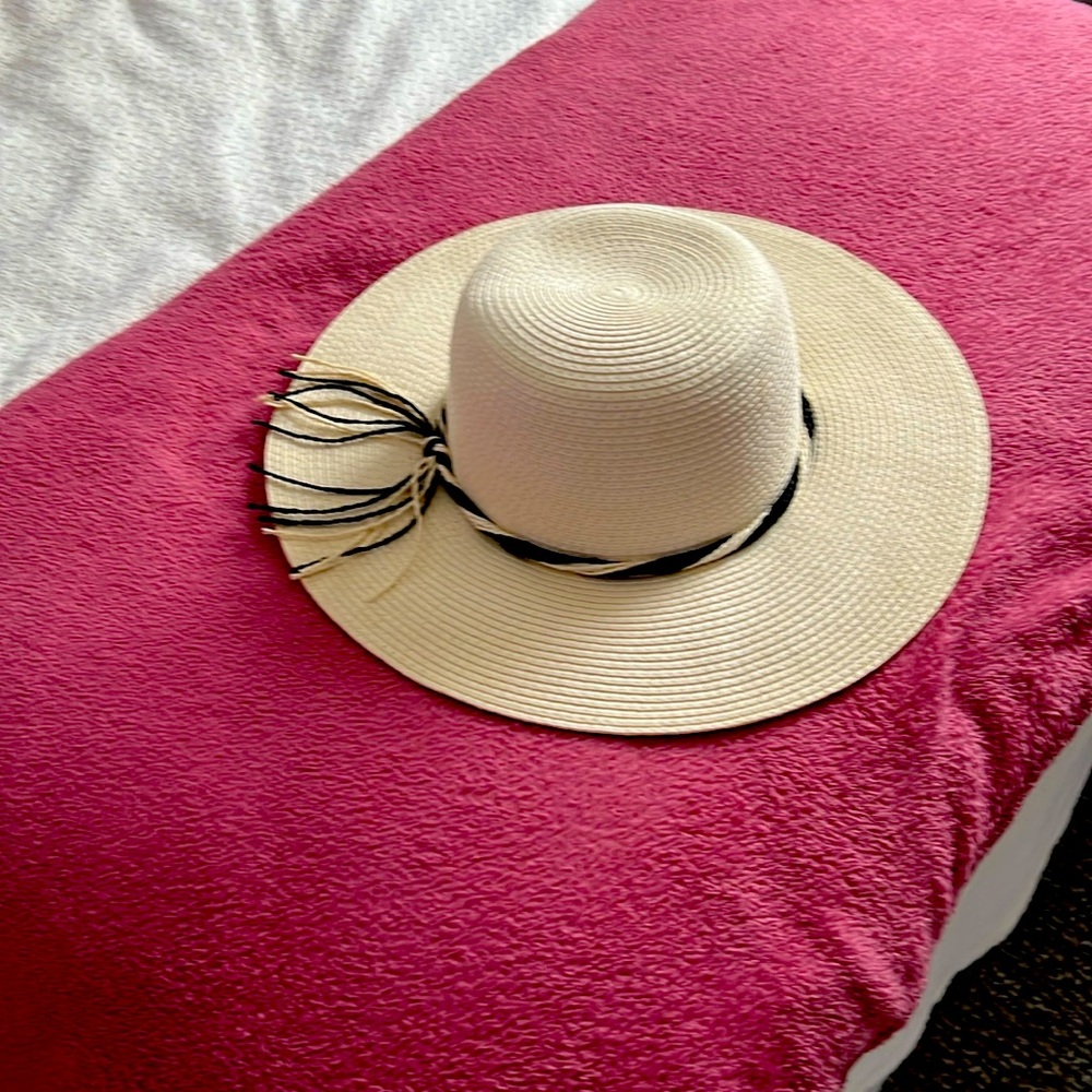 White beach hat with black and white braiding and tassel